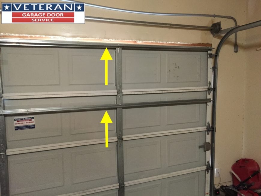 Should I install a strut or replace my garage door section
