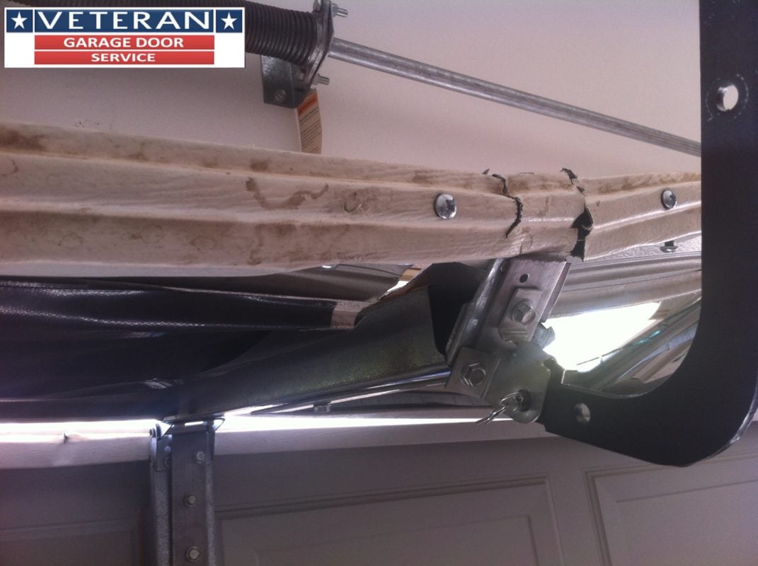 Should I install a strut or replace my garage door section