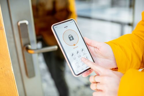 Woman trying to open garage door with her phone as the remote but not working