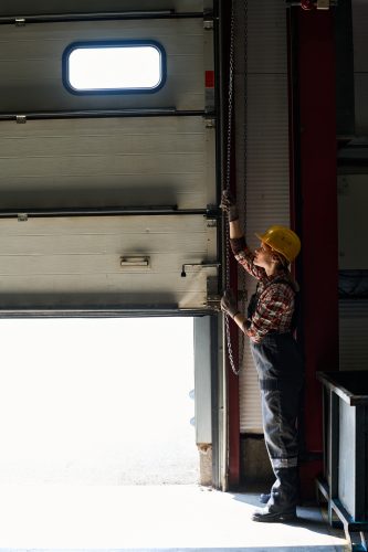 Woman preventing garage door from opening totally